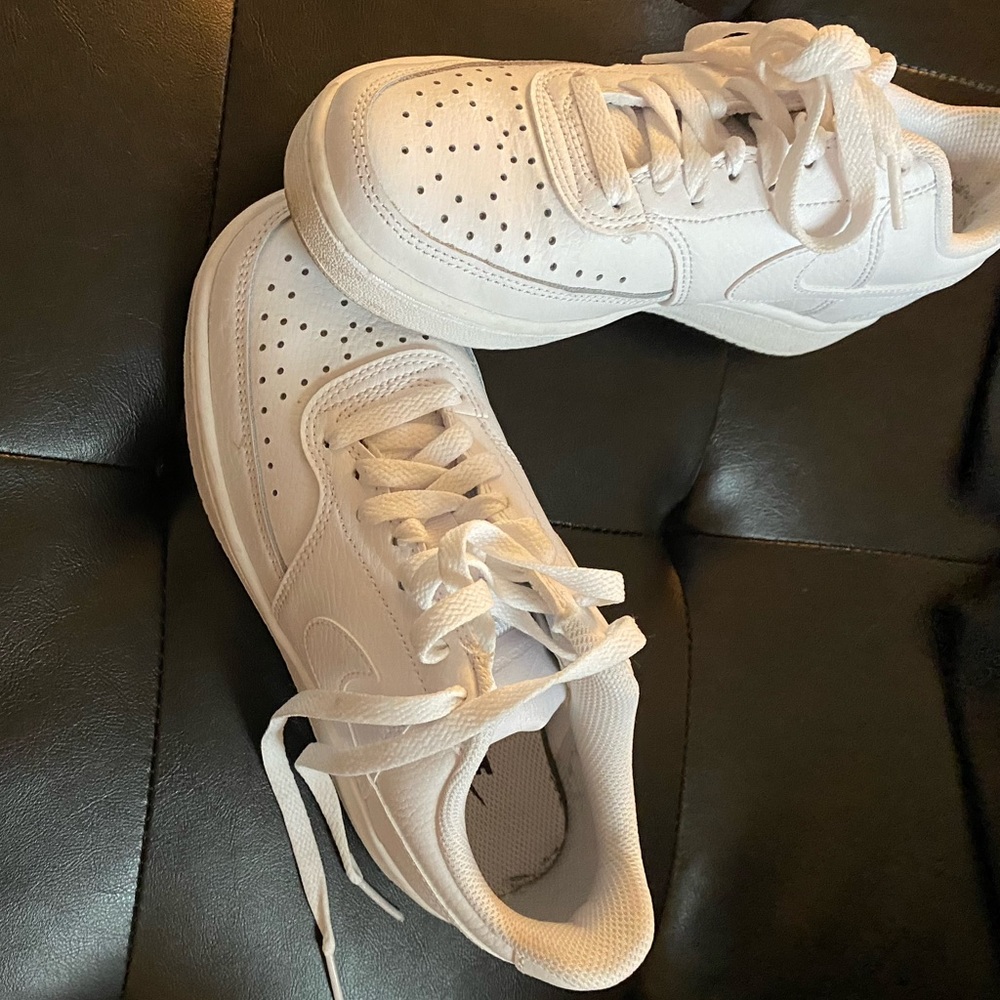 Low top white sneakers.